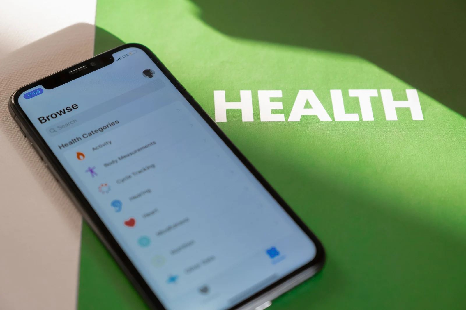 Smartphone displaying health categories beside the word Health.
