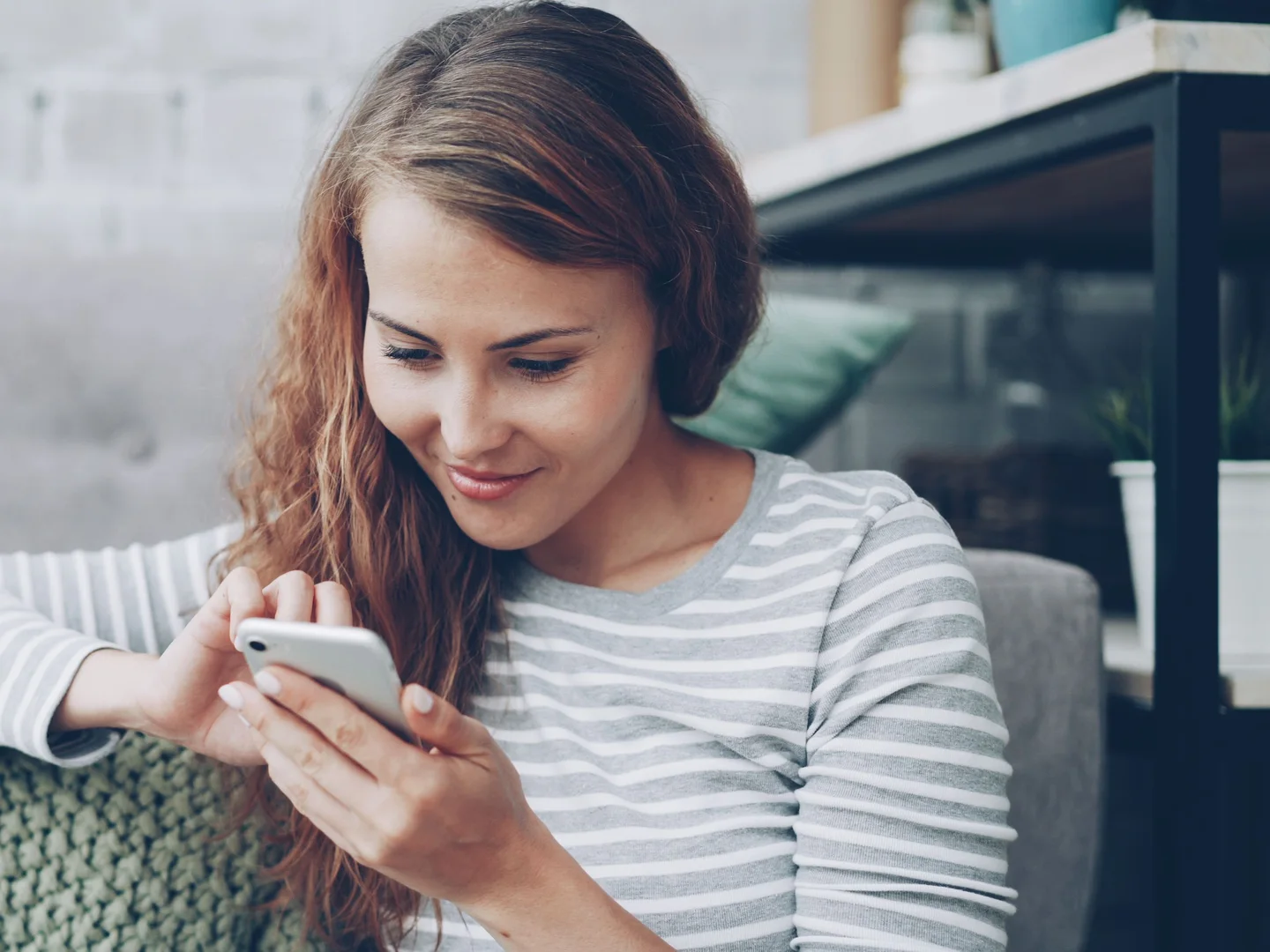 Person at home using a smartphone, representing consumer-facing medical AI and everyday health-information use